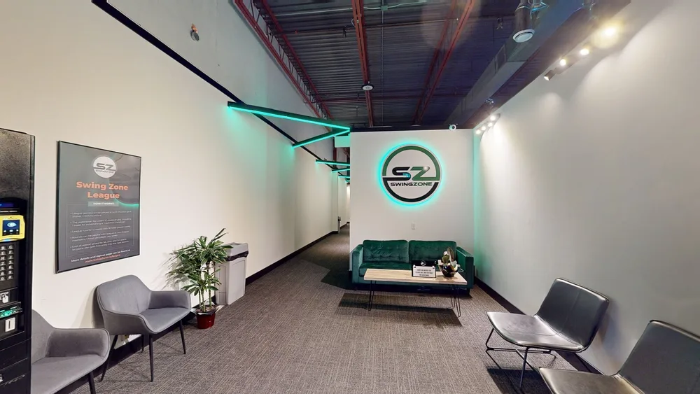 Swing Zone Mississauga lobby with green sofa and illuminated logo